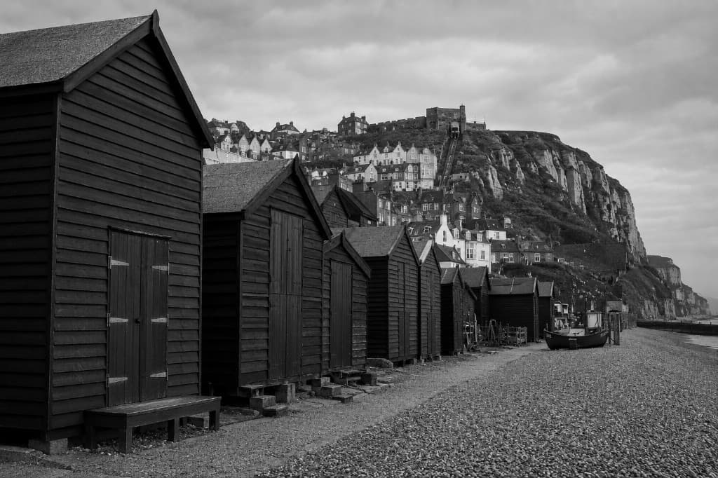 Tall wooden fishing huts on a shingle beach